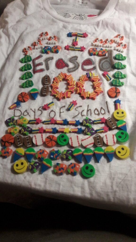 A shirt says I erased 100 days of school and is covered with actual erasers of all different sizes and shapes.