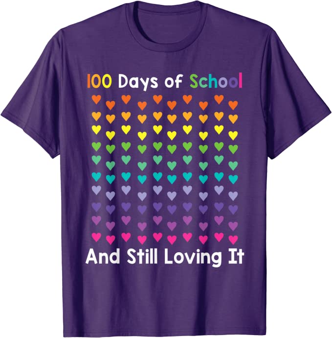 A purple shirt says 100 Days of School And Still Loving It. There are 100 hearts on it in all different colors.