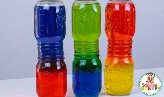 Colorful water in layers in double glass jars